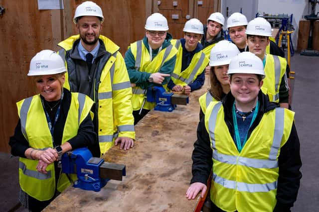 Val Quinan of Tyne Coast College and Adam Johnson, electrical project engineer at Castle Building Services, with some of the electrical students.