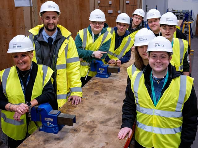 Val Quinan of Tyne Coast College and Adam Johnson, electrical project engineer at Castle Building Services, with some of the electrical students.