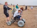 Thomas Lawton, Maureen Morris and Kelly Lawton accompany Hannah Lawton as she puts one of the beach accessible wheelchairs to the test at Roker.