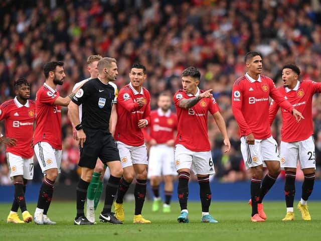 Manchester United players remonstrate with Referee, Craig Pawson following a disallowed goal by Cristiano Ronaldo (4th R) of Manchester United during the Premier League match between Manchester United and Newcastle United at Old Trafford on October 16, 2022 in Manchester, England. (Photo by Stu Forster/Getty Images)