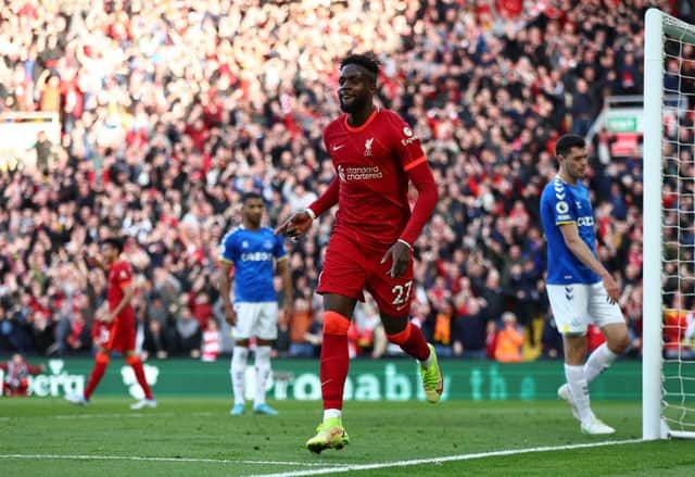 Divock Origi of Liverpool celebrates after scoring their team's second goal during the Premier League match between Liverpool and Everton at Anfield on April 24, 2022 in Liverpool, England. (Photo by Clive Brunskill/Getty Images)