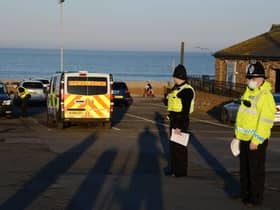 Police officers stop to issue compliance letters to motorists travelling from afar to South Shields seaside, in South Tyneside over the weekend
