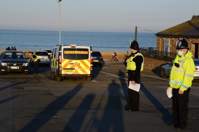 Police officers stop to issue compliance letters to motorists travelling from afar to South Shields seaside, in South Tyneside over the weekend