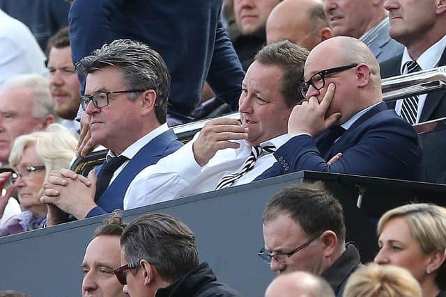 Newcastle United's owner Mike Ashley (C) talks with managing director Lee Charnley (R) ahead of the English Premier League football match between Newcastle United and Tottenham Hotspur at St James' Park in Newcastle-upon-Tyne, north east England on May 15, 2016.