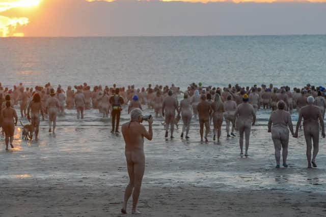 Skinny dippers heading for the sea at dawn.

Photograph: North News and Pictures NNP