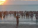 Skinny dippers heading for the sea at dawn.

Photograph: North News and Pictures NNP