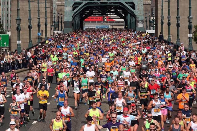 A rainbow over the Tyne Bridge and the mass runners during the Great North Run in Newcastle.