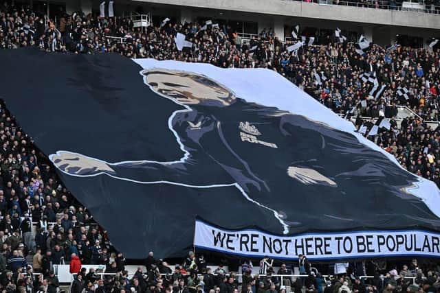 Newcastle fans hold a giant banner featuring an image of Newcastle United's English head coach Eddie Howe, ahead of the English Premier League football match between Newcastle United and Fulham at St James' Park in Newcastle-upon-Tyne, north-east England on January 15, 2023. (Photo by OLI SCARFF/AFP via Getty Images)