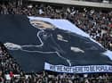 Newcastle fans hold a giant banner featuring an image of Newcastle United's English head coach Eddie Howe, ahead of the English Premier League football match between Newcastle United and Fulham at St James' Park in Newcastle-upon-Tyne, north-east England on January 15, 2023. (Photo by OLI SCARFF/AFP via Getty Images)