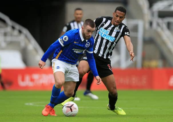 Isaac Hayden challenges Aaron Connolly.