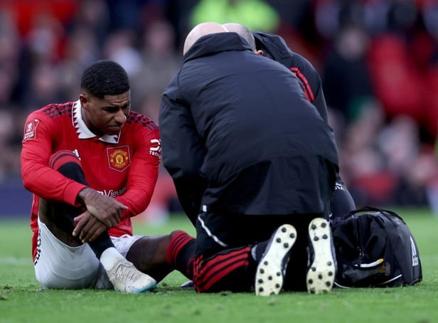 Marcus Rashford of Manchester United receives medical treatment during the Emirates FA Cup Quarter Final match between Manchester United and Fulham at Old Trafford on March 19, 2023 in Manchester, England. (Photo by Clive Brunskill/Getty Images)