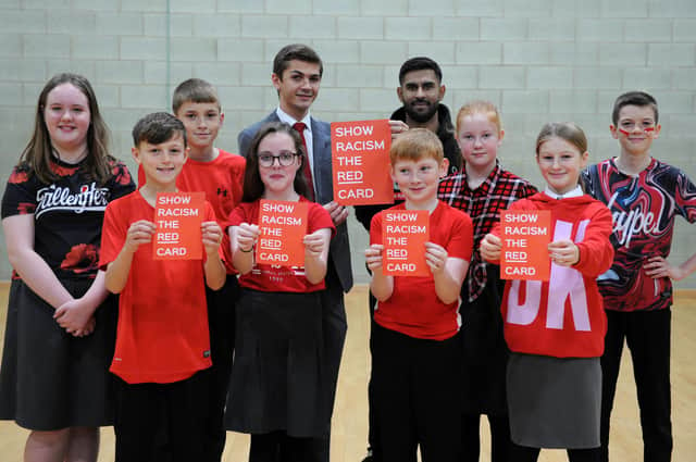 Pupils at St Joseph's take a stand against racism with Cllr Adam Ellison and Show Racism the Red Card education worker Guljar Ahmed