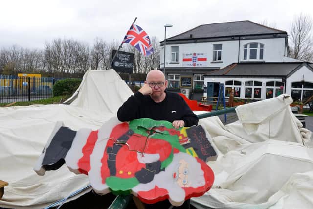 Owner Norman Scott surveys the damage at Dougie's Tavern, but with the Union Jack still proudly flying. Picture by Stu Norton