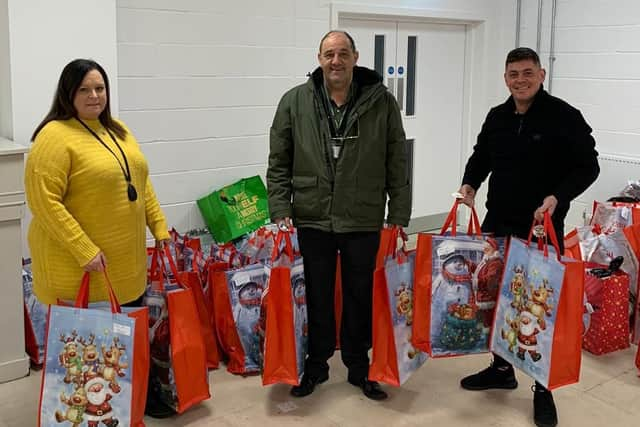 Tony Fada (right) delivering Santa sacks to John Golightly and Sarah Atkinson at the Teenage Unit in Boldon.