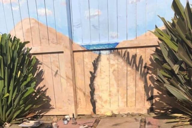 Megan McCall has painted a mural of South Shields coastline on her garden fence.
