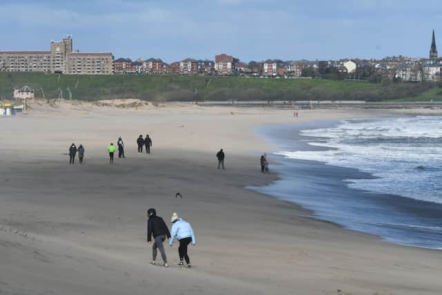 Walkers on the beach at South Shields this morning as blustery conditions hit the region.