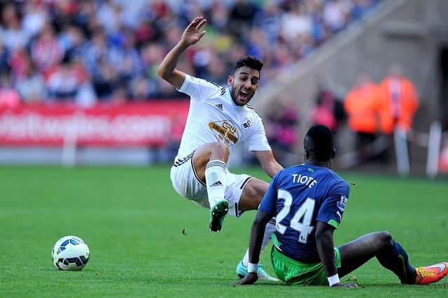 SWANSEA, WALES - OCTOBER 04: Newcastle player Chieck Tiote (r) beats Neil Taylor to the ball during the Barclays Premier League match between Swansea City and Newcastle United at Liberty Stadium on October 4, 2014 in Swansea, Wales. (Photo by Stu Forster/Getty Images)