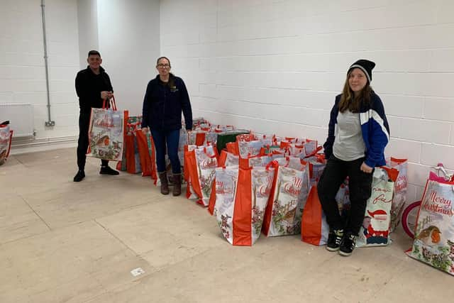 Tony Fada delivering Santa sacks to Marie Burnett and Anne Lisewska at the Key to Life Food Bank in South Shields.