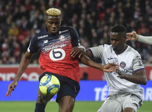 Lille's Nigerian forward Victor Osimhen (L) fights for the ball against Toulouse's Ivorian midfielder Ibrahim Sangare during the French L1 football match between Lille and Toulouse on February 22, 2020 at the Pierre Mauroy Stadium in Villeneuve d'Ascq. (Photo by FRANCOIS LO PRESTI / AFP) (Photo by FRANCOIS LO PRESTI/AFP via Getty Images)