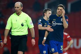Jan Bednarek of Southampton argues with referee Mike Dean after his dismissal against Manchester United. (Photo by Phil Noble - Pool/Getty Images)