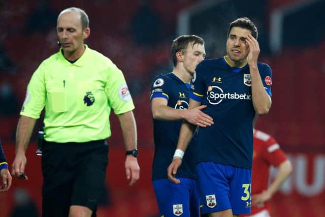 Jan Bednarek of Southampton argues with referee Mike Dean after his dismissal against Manchester United. (Photo by Phil Noble - Pool/Getty Images)
