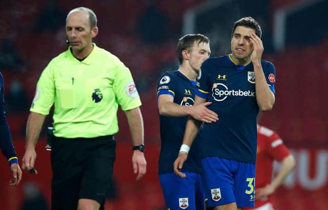 Jan Bednarek of Southampton argues with referee Mike Dean after his dismissal against Manchester United. (Photo by Phil Noble - Pool/Getty Images)