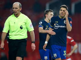 Jan Bednarek of Southampton argues with referee Mike Dean after his dismissal against Manchester United. (Photo by Phil Noble - Pool/Getty Images)