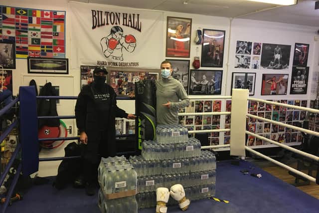 Nico Ali of the Edinburgh Road Premier store, left, with trainer Callum Larson, has donated cash and bottled water to the club.