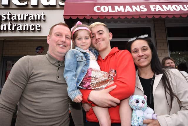 Tom and Michaela Atkinson along with Heidi, five, and Joe ,16, wait for Good Friday fish and chips at Colmans.