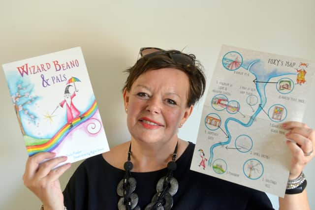 Author Paula Fowler with the first in her trilogy, Wizard Beano and Pals and the accompanying activities sheet. Picture, Sunderland Echo.