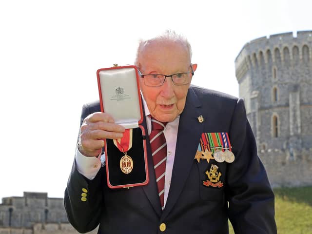 Captain Tom Moore poses with his medal after being made a Knight Bachelor during an investiture at Windsor Castle in July 2020. Picture: Chris Jackson/Pool/AFP via Getty Images.