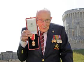 Captain Tom Moore poses with his medal after being made a Knight Bachelor during an investiture at Windsor Castle in July 2020. Picture: Chris Jackson/Pool/AFP via Getty Images.