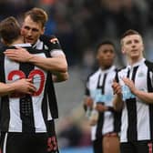Dan Burn embraces Chris Wood of Newcastle United after their sides victory during the Premier League match between Newcastle United and Brighton & Hove Albion at St. James Park on March 05, 2022 in Newcastle upon Tyne, England. (Photo by Stu Forster/Getty Images)