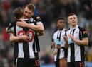 Dan Burn embraces Chris Wood of Newcastle United after their sides victory during the Premier League match between Newcastle United and Brighton & Hove Albion at St. James Park on March 05, 2022 in Newcastle upon Tyne, England. (Photo by Stu Forster/Getty Images)