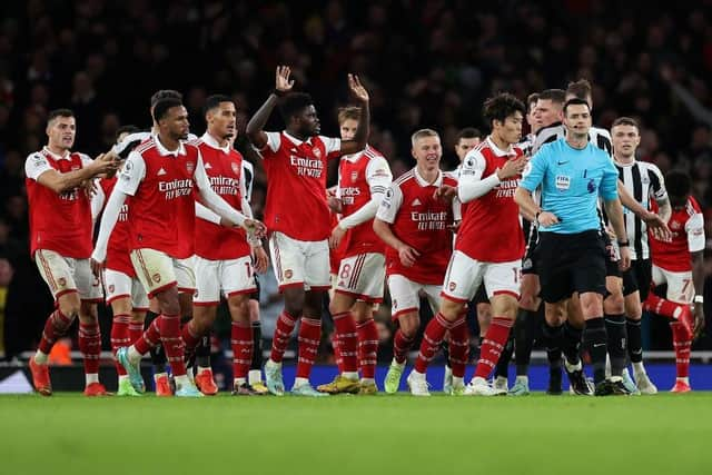 Arsenal players surround the Referee Andy Madley after a late penalty appeal during the Premier League match between Arsenal FC and Newcastle United at Emirates Stadium on January 03, 2023 in London, England. (Photo by Julian Finney/Getty Images)