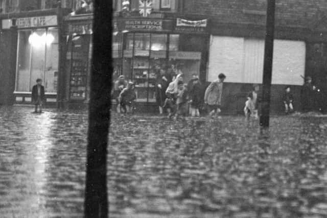 Floods and thunderstorms hit South Tyneside in the days before the Coronation in 1953. Here are people in water which was ankle deep in Ocean Road.