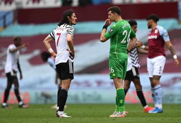 Edinson Cavani of Manchester United interacts with Emiliano Martinez of Aston Villa. (Photo by Shaun Botterill/Getty Images)