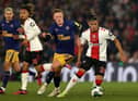 Newcastle United's English midfielder Sean Longstaff (2R) vies with Southampton's Argentinian midfielder Carlos Alcaraz (R) during the English League Cup semi-final first-leg football match between Southampton and Newcastle United at St Mary's Stadium in Southampton, southern England on January 24, 2023. (Photo by ADRIAN DENNIS/AFP via Getty Images)