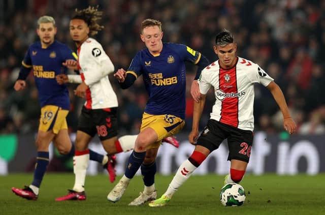 Newcastle United's English midfielder Sean Longstaff (2R) vies with Southampton's Argentinian midfielder Carlos Alcaraz (R) during the English League Cup semi-final first-leg football match between Southampton and Newcastle United at St Mary's Stadium in Southampton, southern England on January 24, 2023. (Photo by ADRIAN DENNIS/AFP via Getty Images)