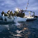 This image provided by the U.S. Navy shows sailors assigned to Explosive Ordnance Disposal Group 2 recovering a high-altitude surveillance balloon off the coast of Myrtle Beach, S.C., Feb. 5, 2023. (U.S. Navy via AP)