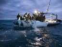 This image provided by the U.S. Navy shows sailors assigned to Explosive Ordnance Disposal Group 2 recovering a high-altitude surveillance balloon off the coast of Myrtle Beach, S.C., Feb. 5, 2023. (U.S. Navy via AP)