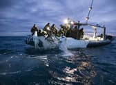 This image provided by the U.S. Navy shows sailors assigned to Explosive Ordnance Disposal Group 2 recovering a high-altitude surveillance balloon off the coast of Myrtle Beach, S.C., Feb. 5, 2023. (U.S. Navy via AP)