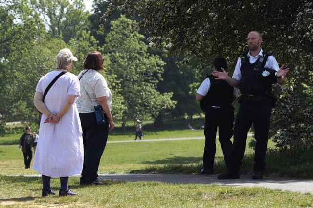 A police officer in conversation with two women in Greenwich Park, London. Police chiefs are facing mounting pressure to review all lockdown fines issued in England and Wales under coronavirus laws. Photo: Yui Mok/PA Wire