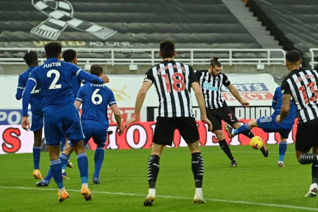Newcastle United's English striker Andy Carroll (R) shoots to scores his team's first goal during the English Premier League football match between Newcastle United and Leicester City at St James' Park in Newcastle-upon-Tyne, north east England on January 3, 2021.