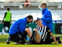 Ciaran Clark receives treatment during a game last month.