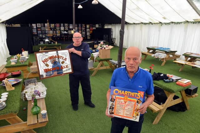 Owner of Dougie's Tavern Norman Scott, in black, with Sophia's granddad Bobby Park, with some of the memorabilia from the auction.