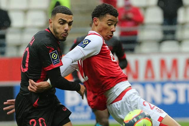 Reims striker Hugo Ekitike, right.