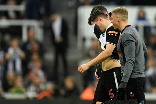 Newcastle United's Swiss defender Fabian Schar leaves the pitch injured during the English Premier League football match between Newcastle United and Arsenal at St James' Park in Newcastle-upon-Tyne, north east England on May 16, 2022.  (Photo by OLI SCARFF/AFP via Getty Images)