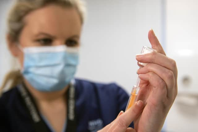 Advanced nurse practitioner Justine Williams prepares a dose of the AstraZeneca/Oxford Covid-19 vaccine at the Lochee Health Centre in Dundee. The NHS is ramping up its vaccination programme with the newly approved jab, with 530,000 doses available for rollout across the UK.