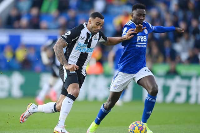 Callum Wilson of Newcastle United is challenged by Wilfred Ndidi of Leicester City during the Premier League match between Leicester City and Newcastle United at The King Power Stadium on December 12, 2021 in Leicester, England. (Photo by Gareth Copley/Getty Images)